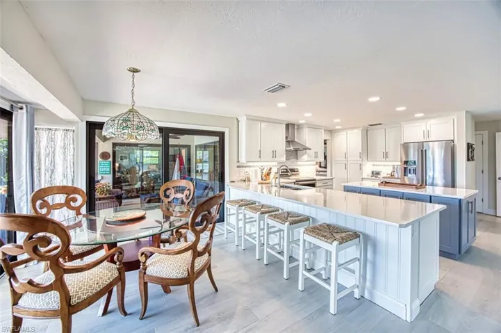 Dining room with light wood-style floors, recessed lighting, and french doors