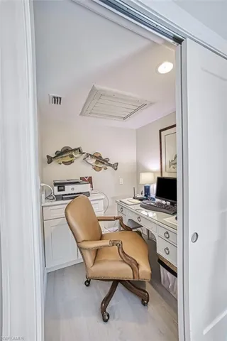 Office space with cooling unit, built in study area, and recessed lighting