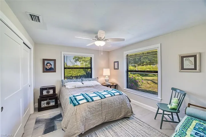 Bedroom with a closet, wood finished floors, and ceiling fan