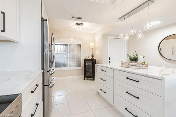 Island with granite waterfall countertops and drawers galore.