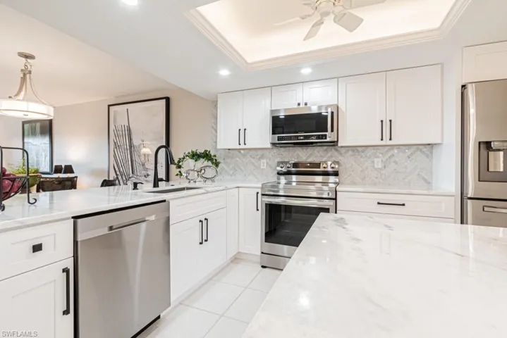 Kitchen with marble herringbone backsplash.