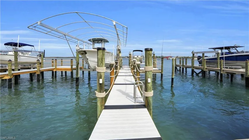 Dock area with a water view and boat lift - Virtually Edited Image