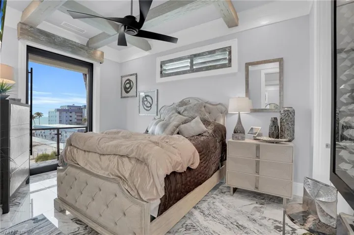 Bedroom with marble look tile flooring, a ceiling fan, beamed ceiling, coffered ceiling, and access to exterior - Virtually Edited Image