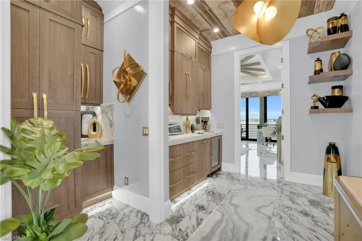 Hallway featuring light marble finish floors, recessed lighting, and beverage cooler - Virtually Edited Image