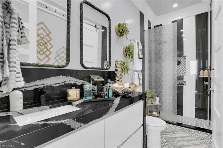Full bath with a walk in shower, vanity, and crown molding - Virtually Edited Image