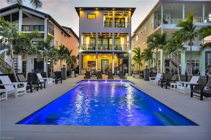 Rear view of property featuring stairway, a patio, and ceiling fan - Virtually Edited Image
