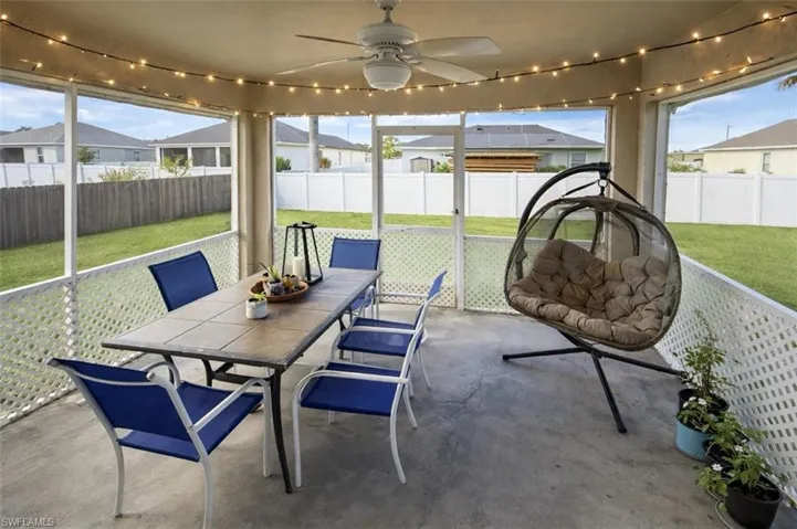 Sunroom featuring ceiling fan, outdoor dining space, and healthy amount of natural light