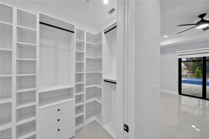 Spacious closet with visible vents and a ceiling fan