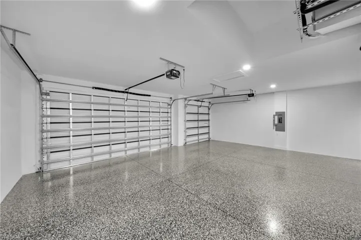 Garage with electric panel and a garage door opener