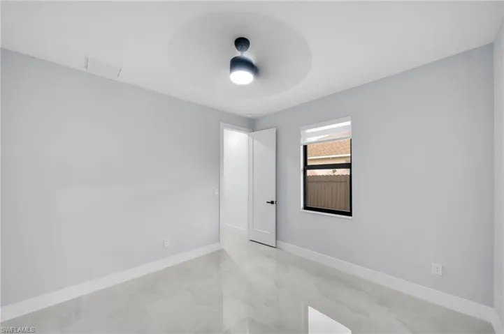 Spare room with baseboards, visible vents, and ceiling fan