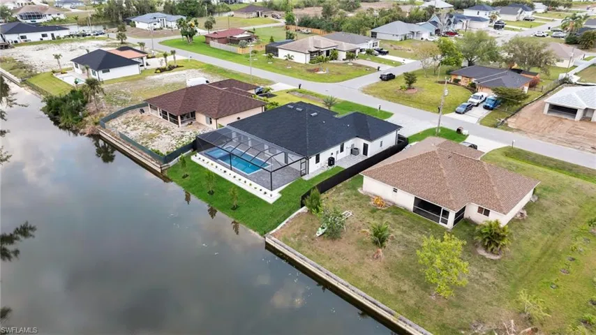 Birds eye view of property featuring a residential view and a water view