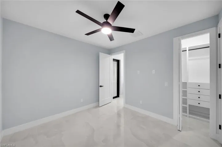 Unfurnished bedroom with ceiling fan, a closet, visible vents, and baseboards