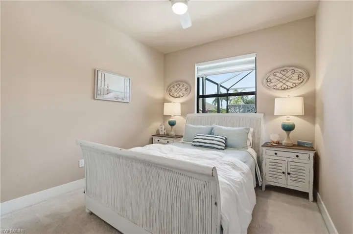 Carpeted bedroom with baseboards and ceiling fan