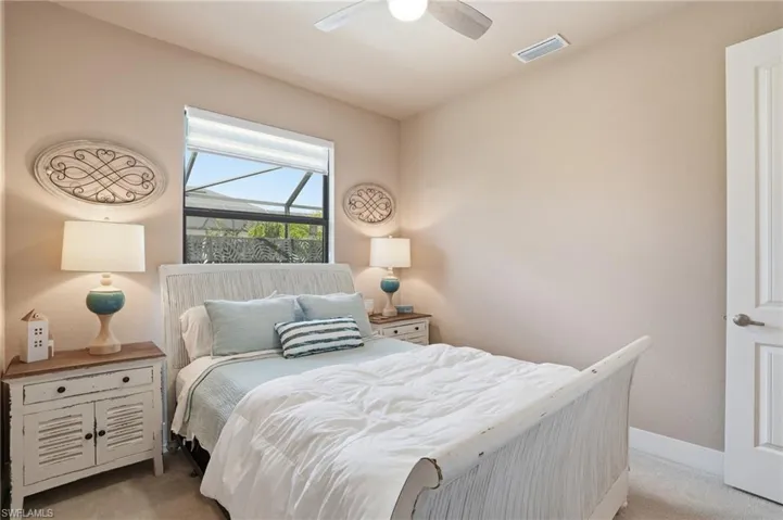 Bedroom with light carpet and ceiling fan