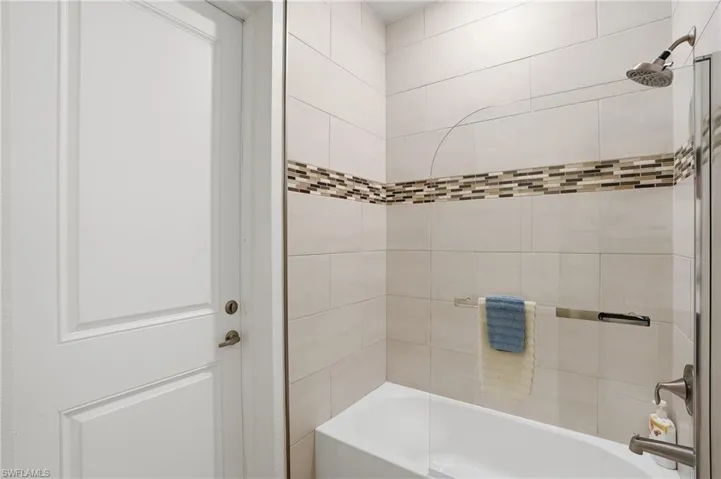Full bath with shower / tub combination, door to lanai