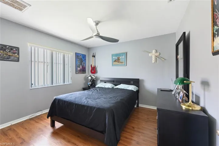 Bedroom featuring wood finished floors and a ceiling fan
