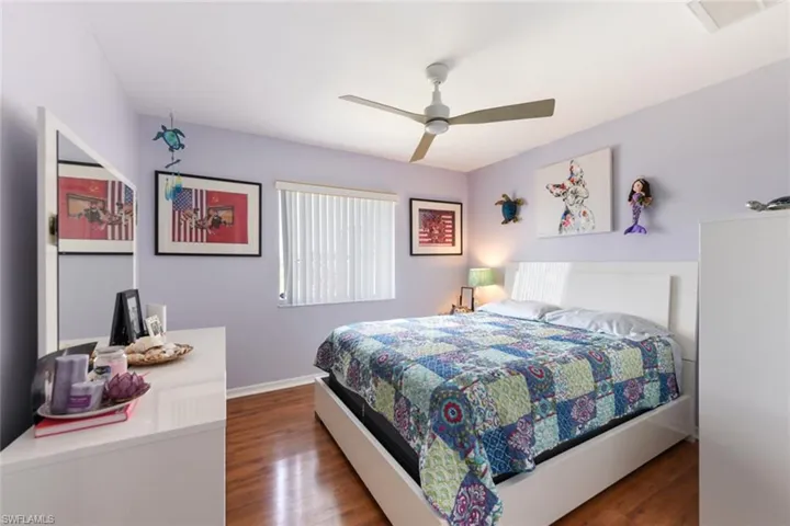 Bedroom with dark wood-type flooring and ceiling fan