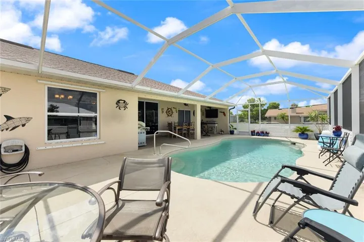 View of swimming pool with a patio area, a sunroom, a lanai, and a grill