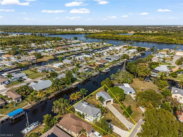 Aerial perspective of suburban area featuring a nearby body of water