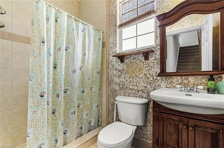 Bathroom featuring vanity and a stall shower