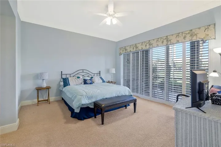Bedroom with carpet flooring, ornamental molding, and ceiling fan