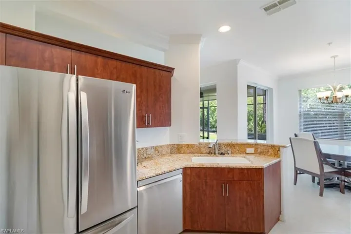 Wonderful kitchen with open views of preserve with lush landscape from the dining room.