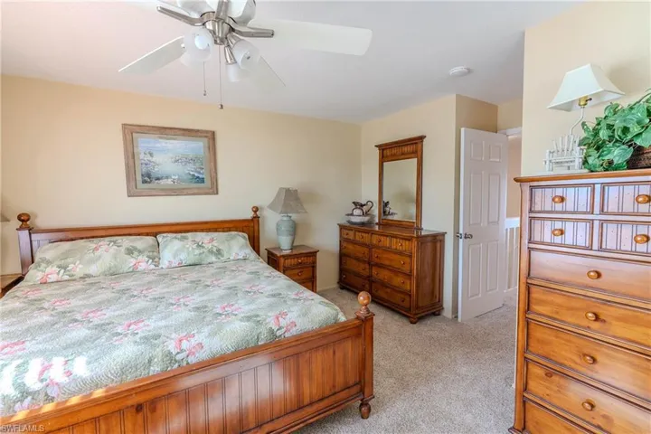 Bedroom with light carpet and ceiling fan