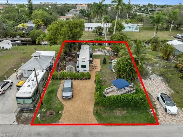 Aerial view of property and surrounding area featuring property boundaries highlighted