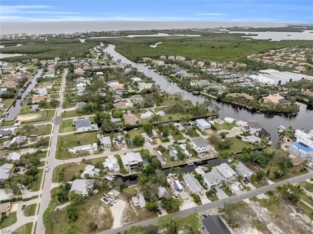 Aerial view of property's location with nearby suburban area and a nearby body of water