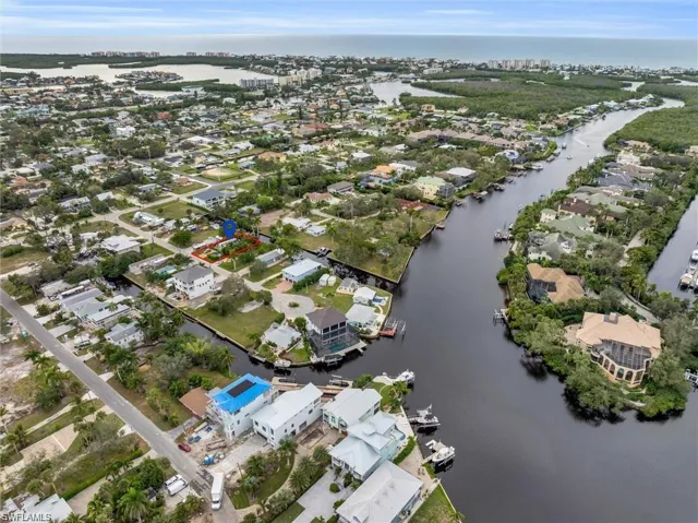 Aerial view of residential area featuring a nearby body of water