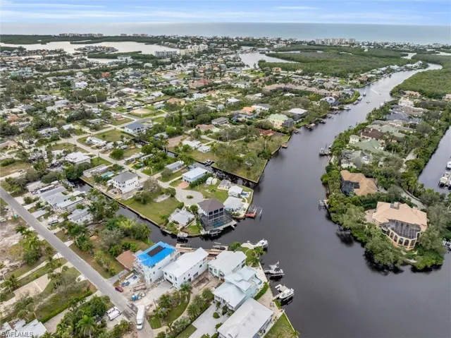 View of property location featuring a large body of water and nearby suburban area
