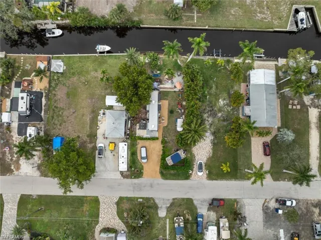 Aerial view of property and surrounding area featuring a nearby body of water
