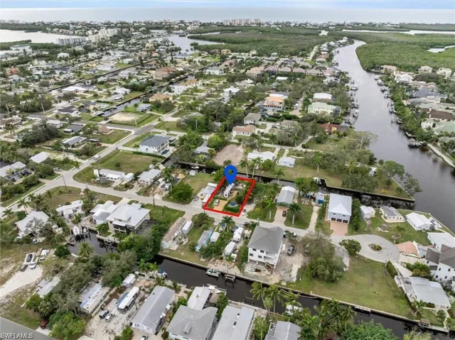 Aerial view of property's location featuring property parcel outlined and nearby suburban area