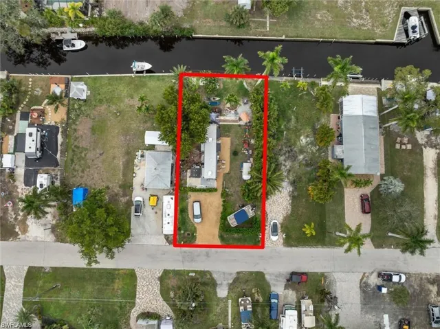 Aerial view of property's location with a large body of water and property parcel outlined