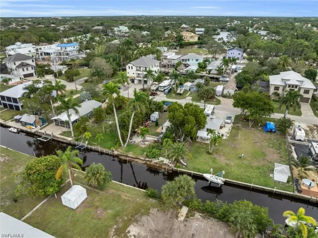 Aerial overview of property's location with nearby suburban area and a large body of water