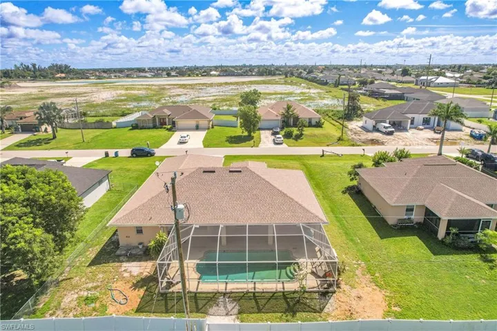 Aerial perspective of suburban area with a pool area