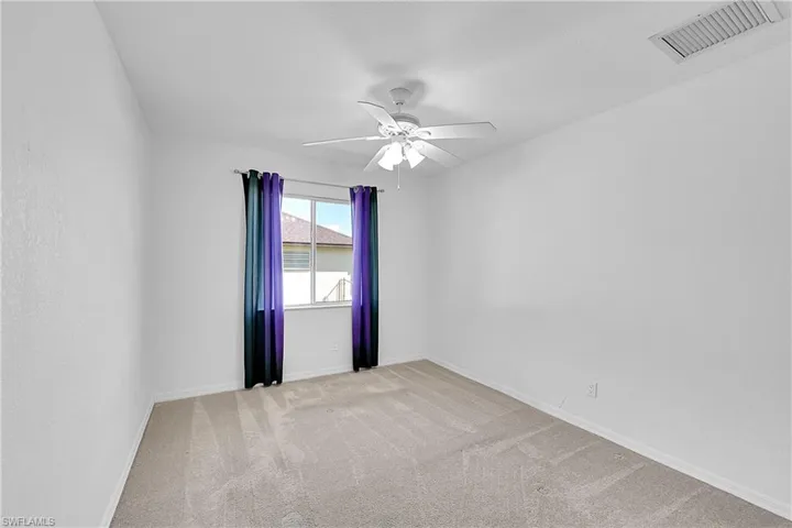 Unfurnished room with light carpet and ceiling fan