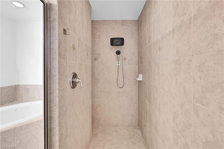 Full bath with a stall shower and a garden tub