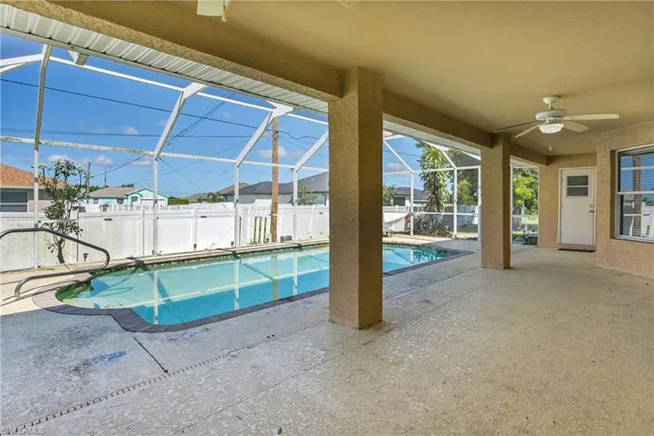 Swimming pool with a patio area, a ceiling fan, a sunroom, and a lanai