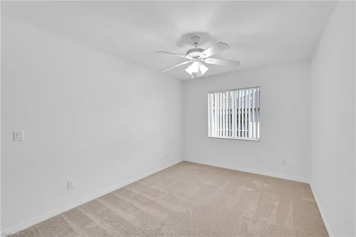 Unfurnished room with light carpet and ceiling fan