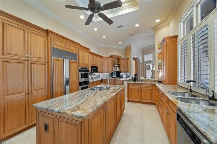 Kitchen featuring open shelves, ceiling fan, stainless steel appliances, and a sink