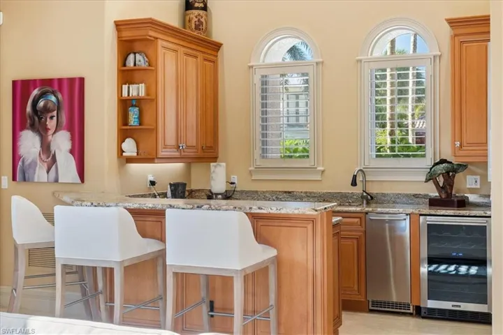 Bar featuring a sink and beverage cooler