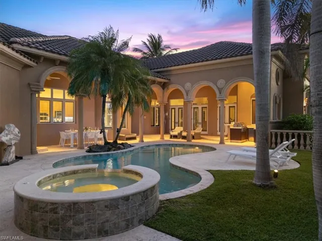 View of pool featuring a yard, a patio, a pool with connected hot tub, and french doors