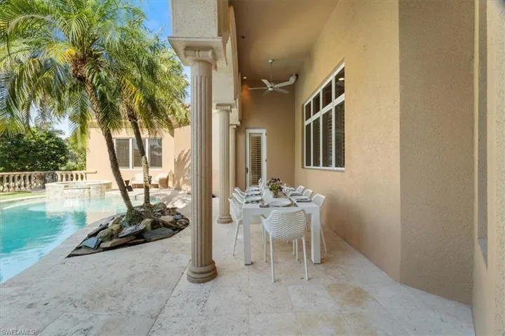 View of patio / terrace featuring a pool with connected hot tub and ceiling fan