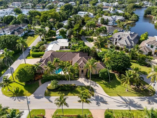 Aerial view of residential area featuring a nearby body of water