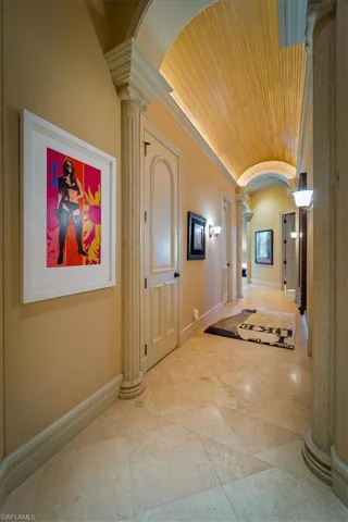 Hall with decorative columns, vaulted ceiling, wooden ceiling, and arched walkways