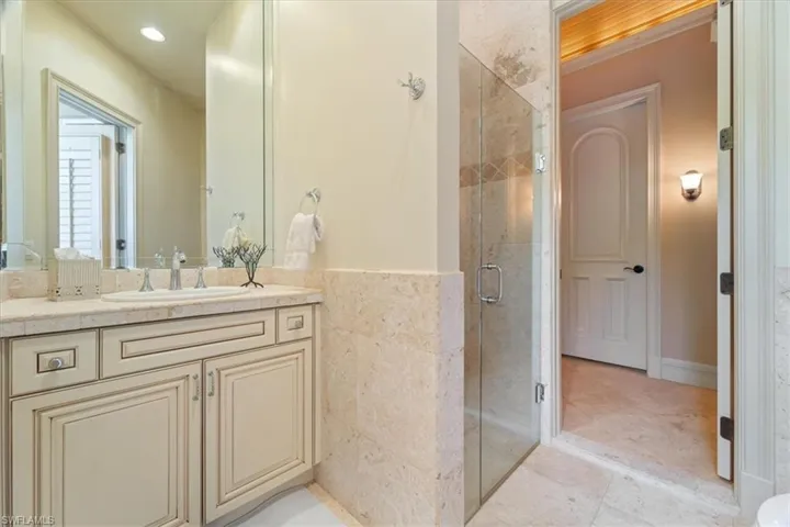 Full bathroom/pool bath featuring tile patterned floors, vanity, recessed lighting, and a stall shower
