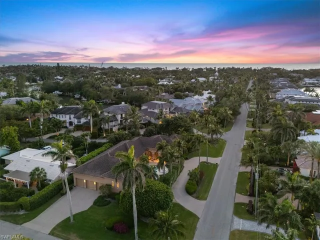 Aerial view at dusk with a residential view and a water view