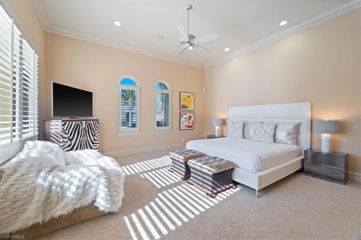 Bedroom featuring carpet, baseboards, and multiple windows