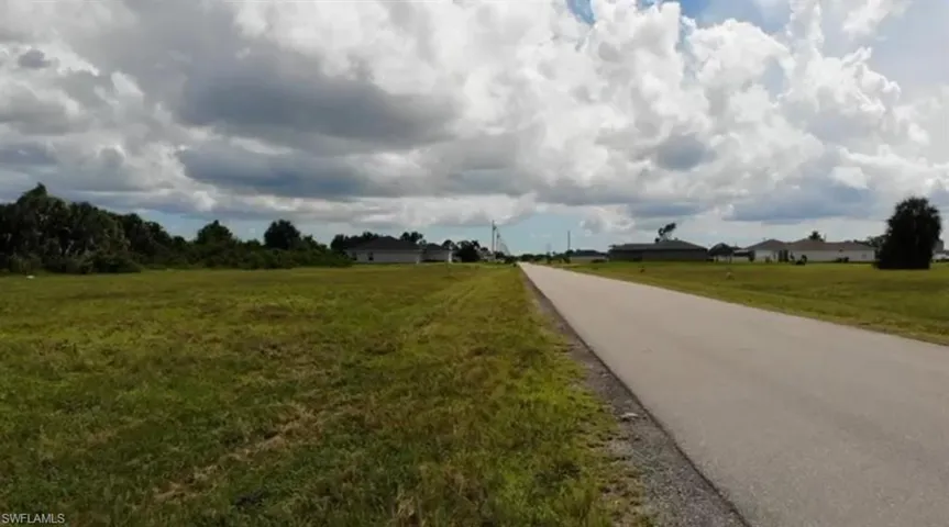 View of asphalt street featuring a view of countryside